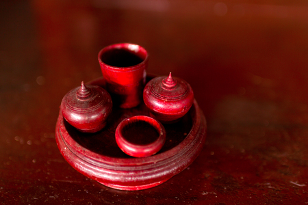 Model wooden cup thai style in wooden plate.の写真素材