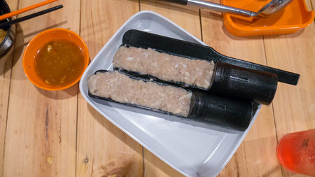 Minced pork for sukiyaki and sauce on wood table.の写真素材