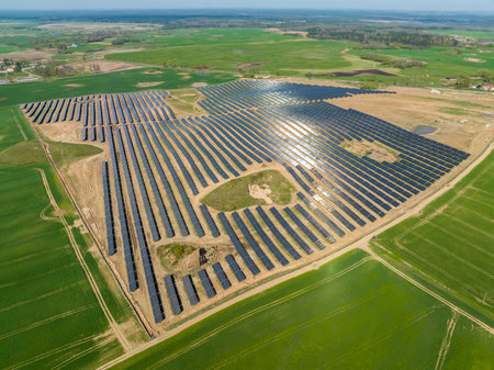 Aerial view of solar power plant with rows of panels for producing clean ecological electric energyの写真素材