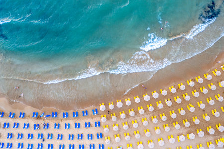 Aerial view of beautiful beach with sunbeds and umbrellasの写真素材