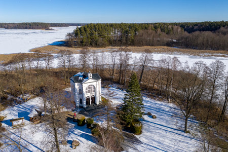 Studzieniczna, Augustow - chapel on the island - winter drone aerial photography, Poland landscape on sunny dayの写真素材
