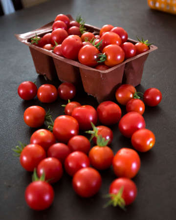 Red tomatoes splayed out upon a tableの写真素材