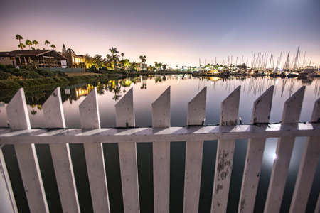 A white fence spans the water in Point Lomaの写真素材