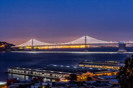The bridge is glowing in the early night over the bay.の写真素材