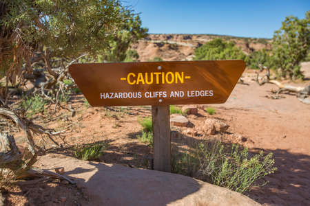 Caution hazardous cliffs and ledges near some arches in Moab, Utahの写真素材