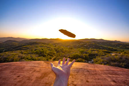 Rock tossed up in the airの写真素材