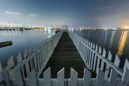White picket fences on the waterの写真素材