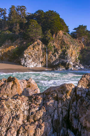 The waterfall is shot straight on from just above sea levelの写真素材