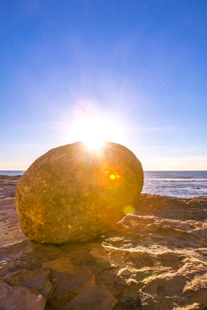 Large stone on the shore of San Diego at Cabrillo beachの写真素材