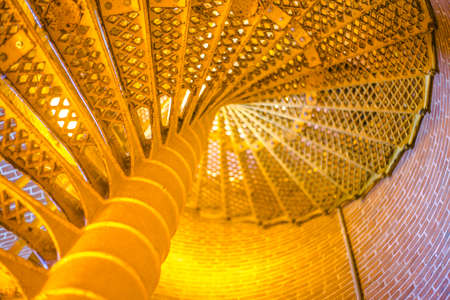 Spiral staircase bright yellow and ample blur and copy spaceの写真素材