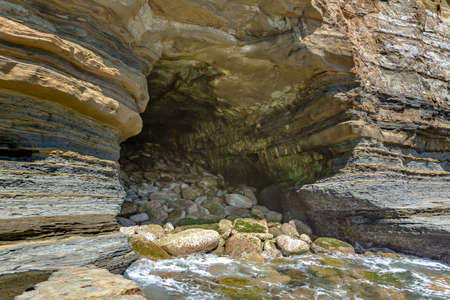 Exterior of a cave in La Jolla California at mid day. The beautiful rock cave at the sea from the outside of the cave at mid day.の写真素材
