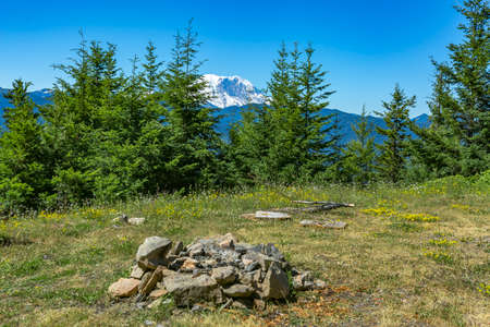 Camp fire pit in Washington with Mount Rainier. Hiking and traveling views near Mount Rainier in Washington over the summerの写真素材