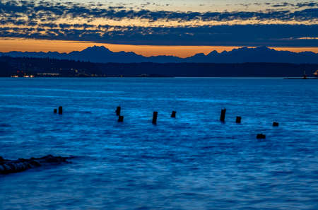 abandoned wooden pillars in the Tacoma bay. The bay in Tacoma Washington at sunset and into nightfallの写真素材