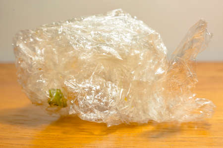 Plastic food wrap crumpled up isolated on background wood. Plastic Bubble Cushioning Wrapの写真素材