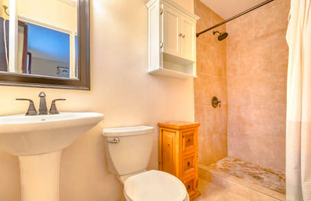 Modern clean and open bathroom in California home downstairs with side table and wall cabinet. Wonderful California home in San Diego county. Real estate listings with powerful visuals. の写真素材