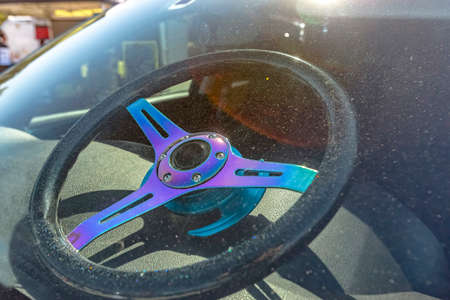 Steering wheel sitting on a dashboard shot through the windshield. Custom cars in Southern California summer 2017の写真素材