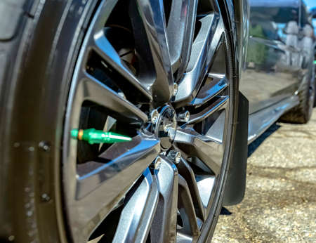 Close shot of chrome rims on a black car. Custom cars in Southern California summer 2017の写真素材
