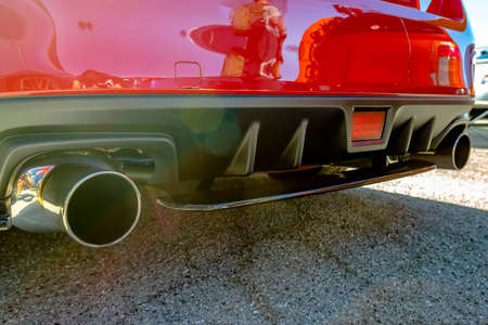 Stainless exhaust pipe at the bottom of red car. Various vehicle details in Southern California.の写真素材