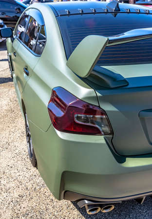 Matte green car with dark tail lights and spoiler. Custom cars in Southern California summer 2017の写真素材