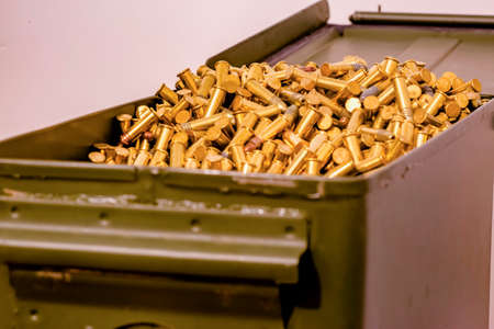 Open, green ammo box full of bullets