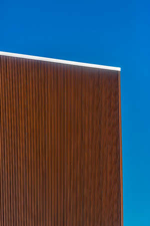 Brown metal panels and silver lining with blue sky