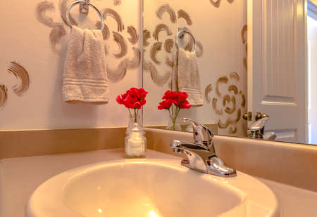 Sink of luxury bathroom with red flower