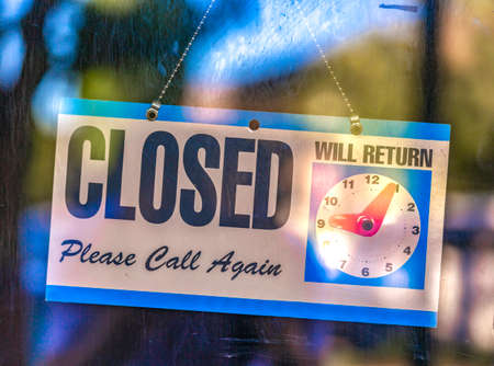 Closed sign with clock displayの写真素材