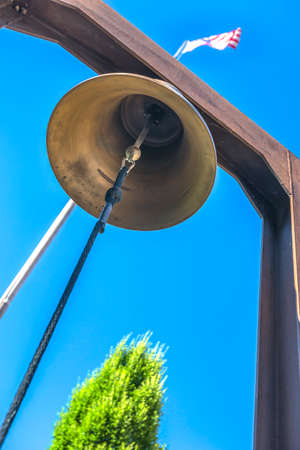 Bell outside of building American Flag