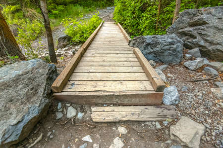 Bridge on Rock Canyon trail in Provo Canyon on a late afternoon with golden light. The bridge goes...