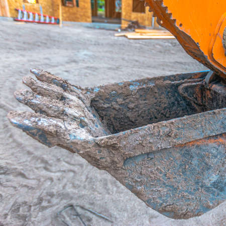 Excavating claw tractor for scooping dirt square