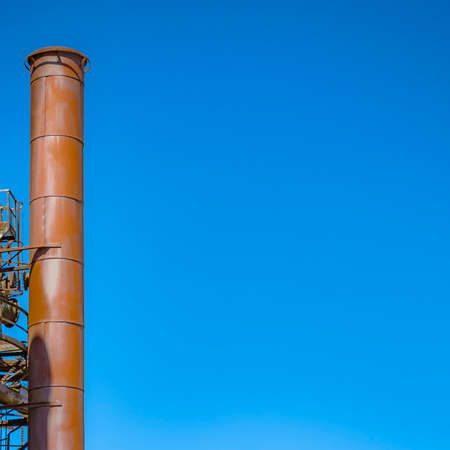 Factory pipe aginst a clear blue skyの写真素材