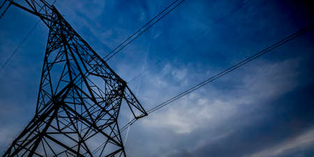 Power lines running through big scaffolding towersの写真素材