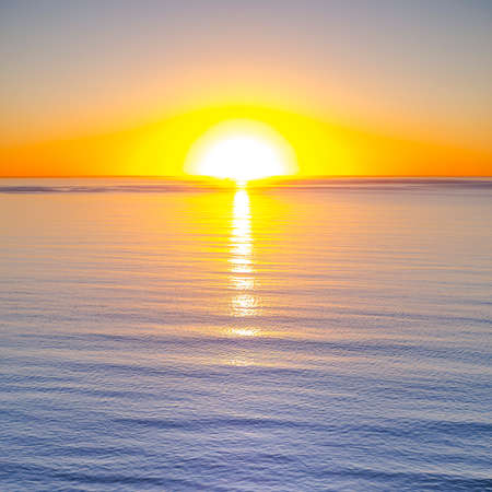 Amazing sunset with orange sky and calm waterの写真素材