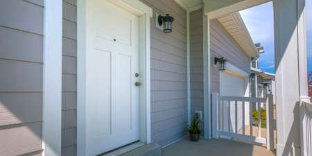 White front door and porch of home on a sunny dayの写真素材