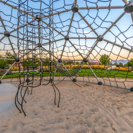 Park and homes seen from inside a dome climberの写真素材