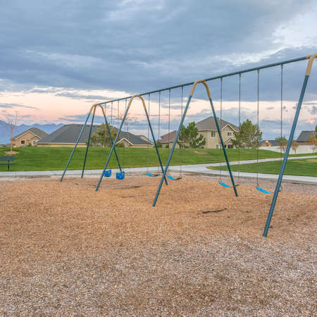 Swings on playground near homes in Saratoga Utahの写真素材