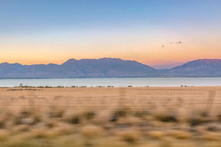 Utah Lake against mountain seen from Highway 68の写真素材