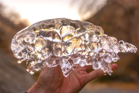 Close up of ice found in river with sun behindの写真素材