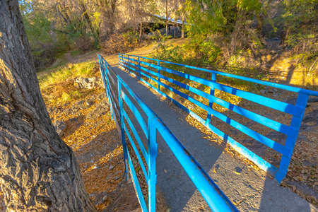 Small bridge over river blue railing off centerの写真素材