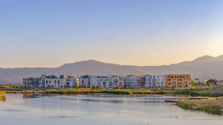 Buildings in Oquirrh Lake against mountain and sky