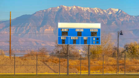 Baseball field with scoreboard view and mountainsの写真素材