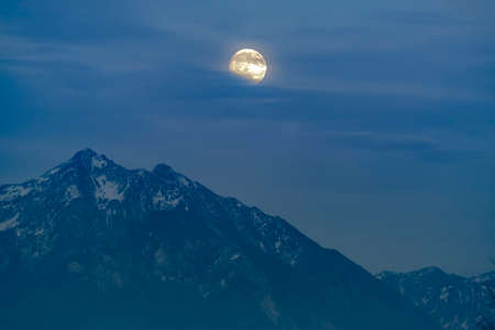 Moon on a foggy night over Timpanogos mountainsの写真素材