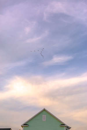 Birds and cloudy sky over home in Daybreak Utahの写真素材