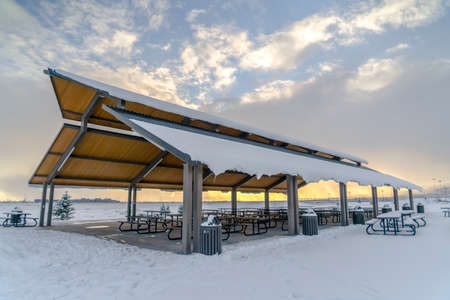 Eeating area with snowy roof on a frosty landscapeの写真素材
