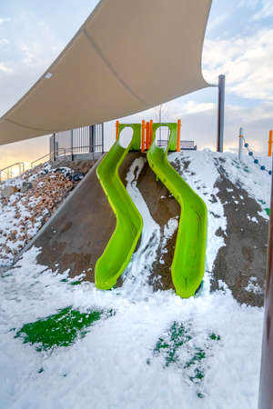 Slides on snowy playground in Eagle Mountain Utahの写真素材