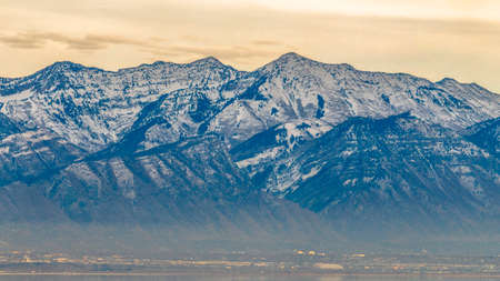 The beautiful Mount Timpanogos against cloudy skyの写真素材