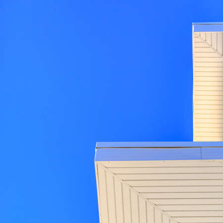 Underside of a roof against clear blue skyの写真素材