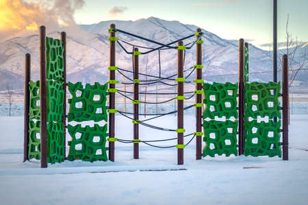 Utah playground and mountain blanketed with snowの写真素材