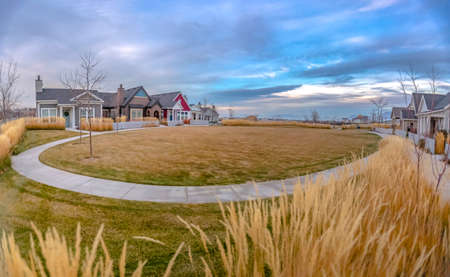 Homes around lawn with circular path in Daybreakの写真素材