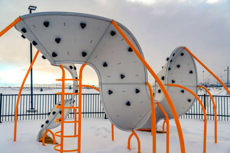 Playground against snowy landscape and cloudy skyの写真素材